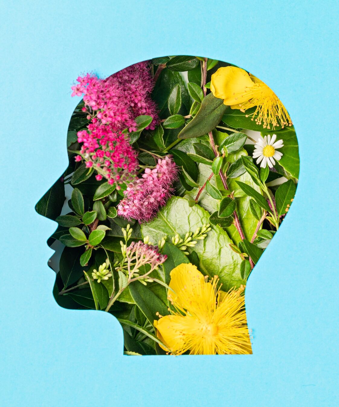 Papercut head with green leaves and flowers. Mental health, emotional wellness, contented emotions